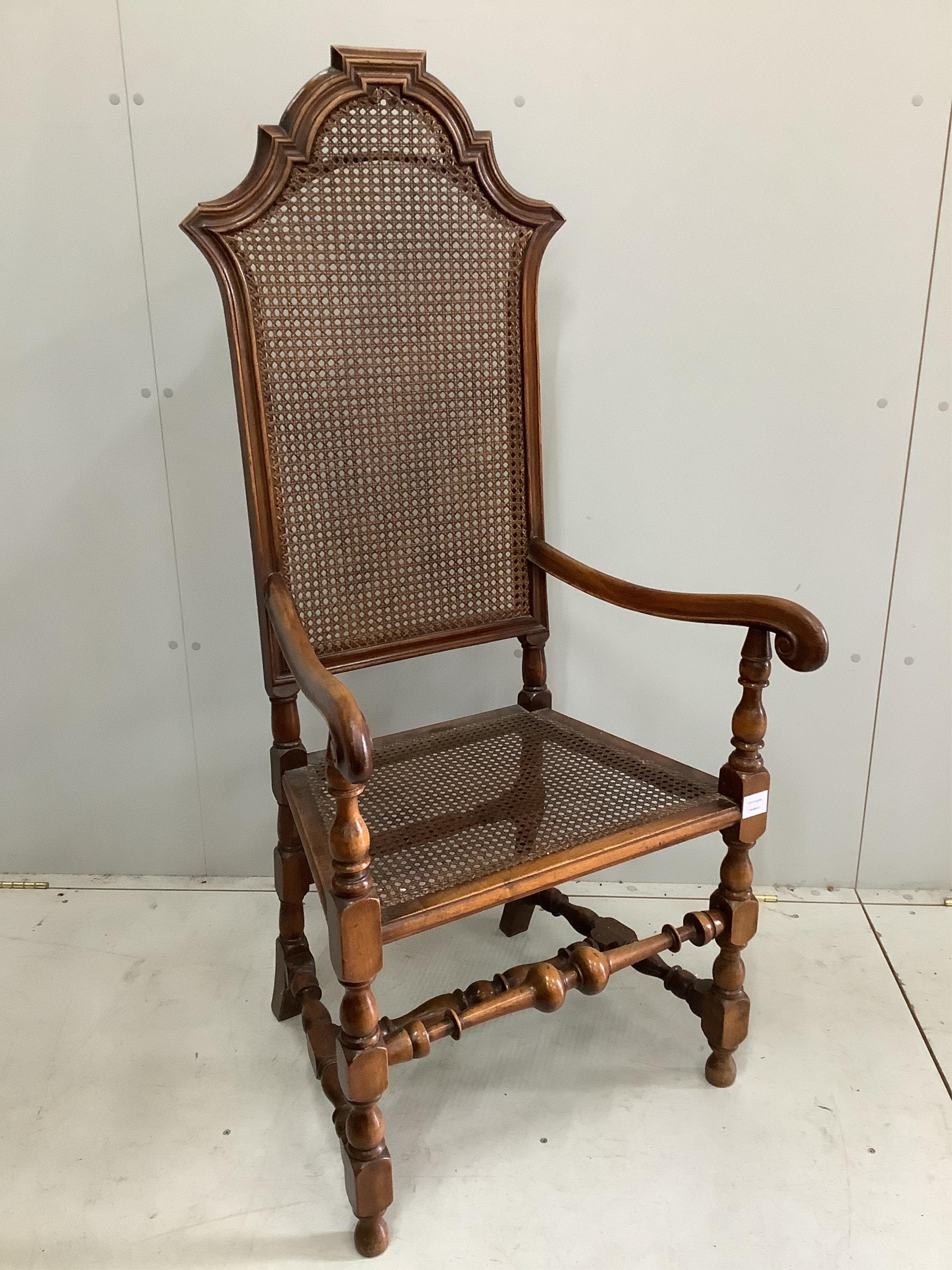 An early 20th century Carolean style caned beech elbow chair, height 138cm. Condition - fair to good